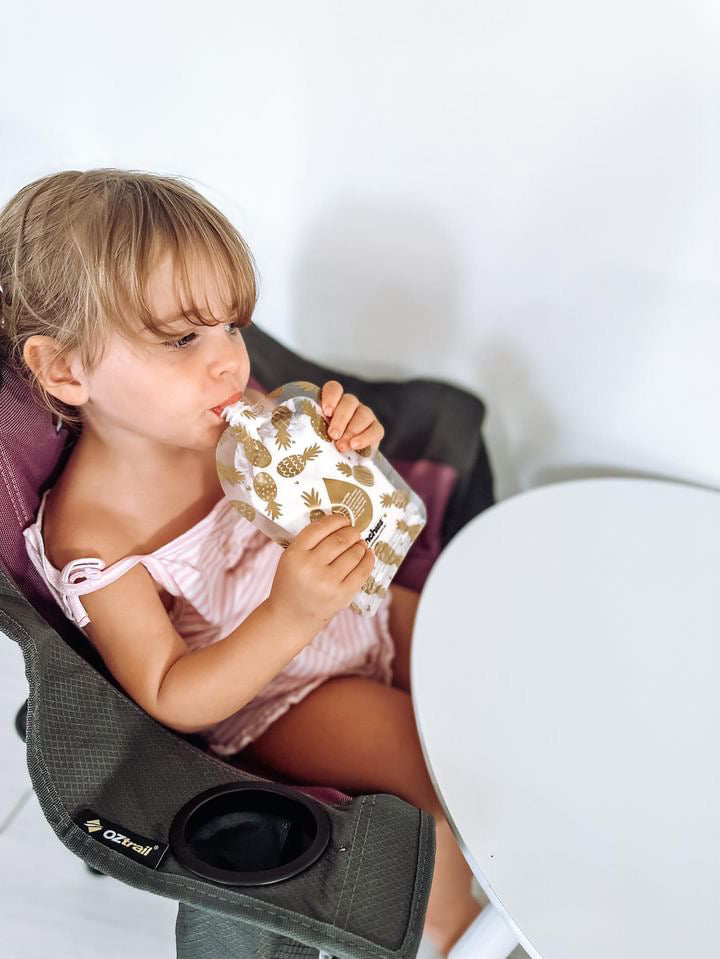Girl drinking from reusable yogurt pouch