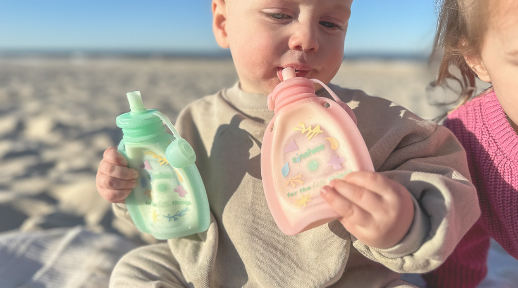 baby drinking yoghurt from silicone food pouch