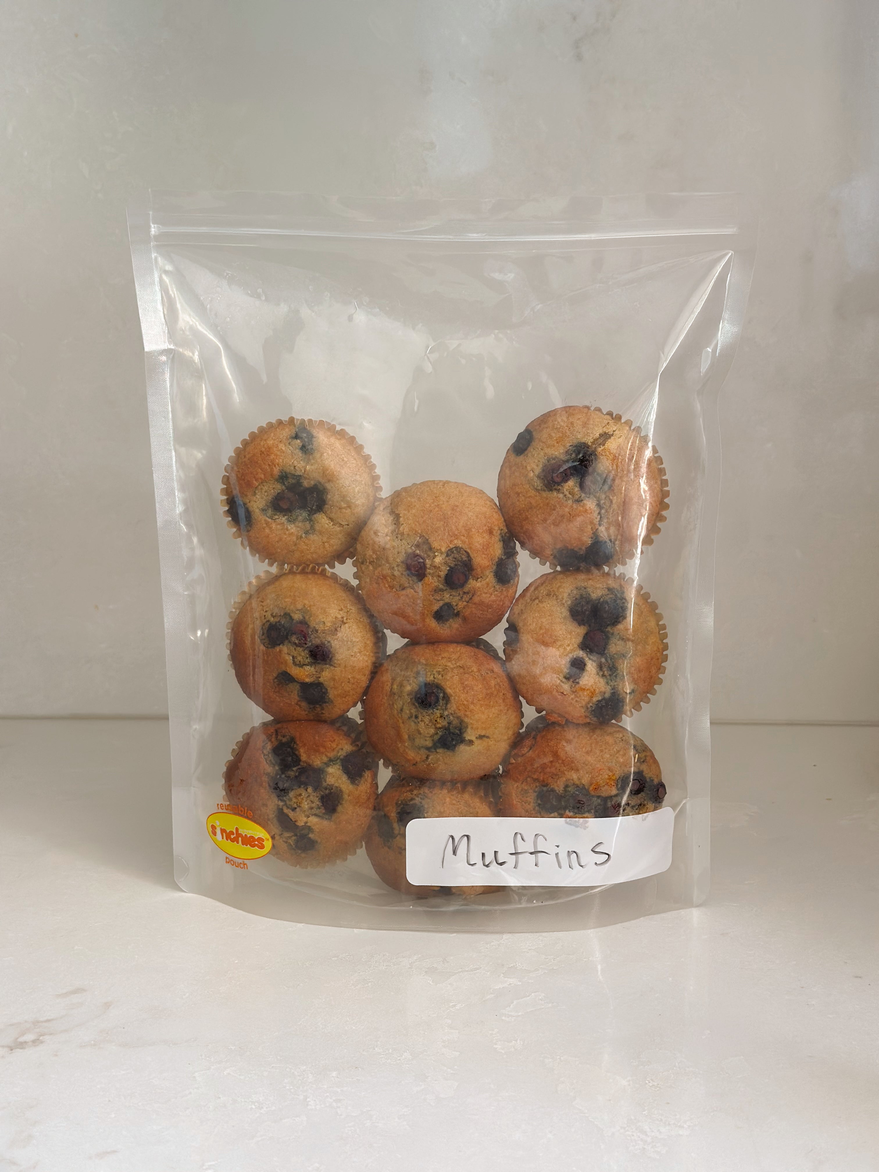 Packaged muffins with a label on a white background