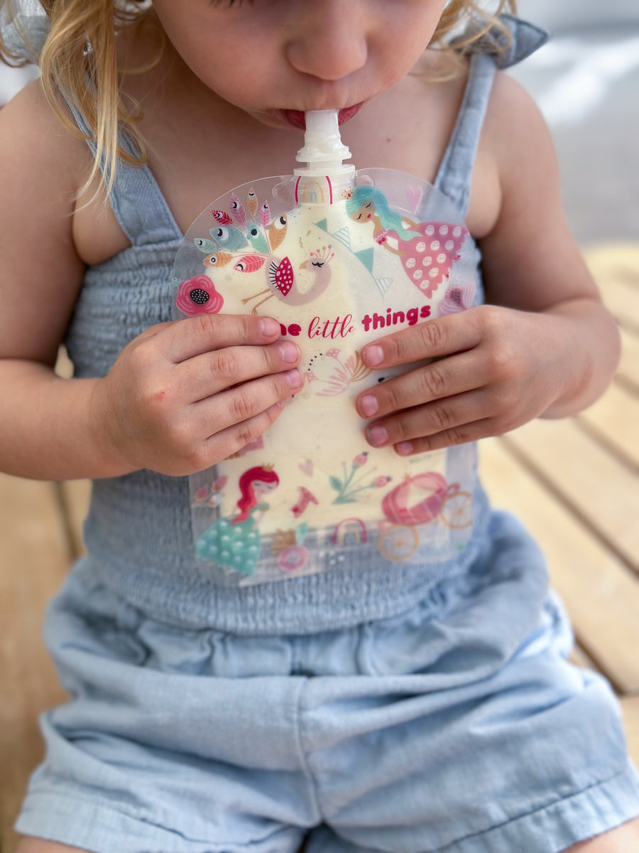 Girl drinking yoghurt from princess food pouch
