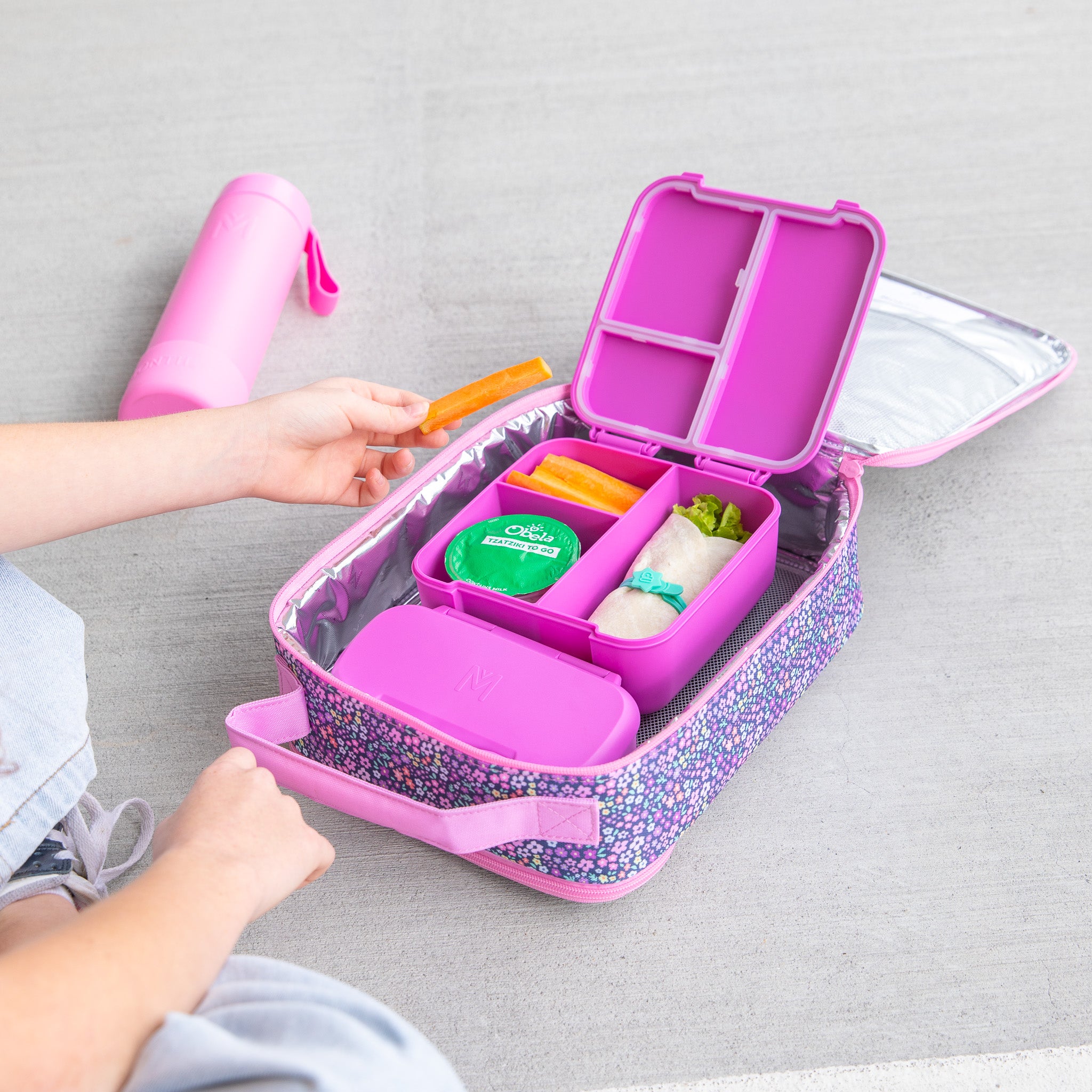 Purple bento box with compartments on a gray surface