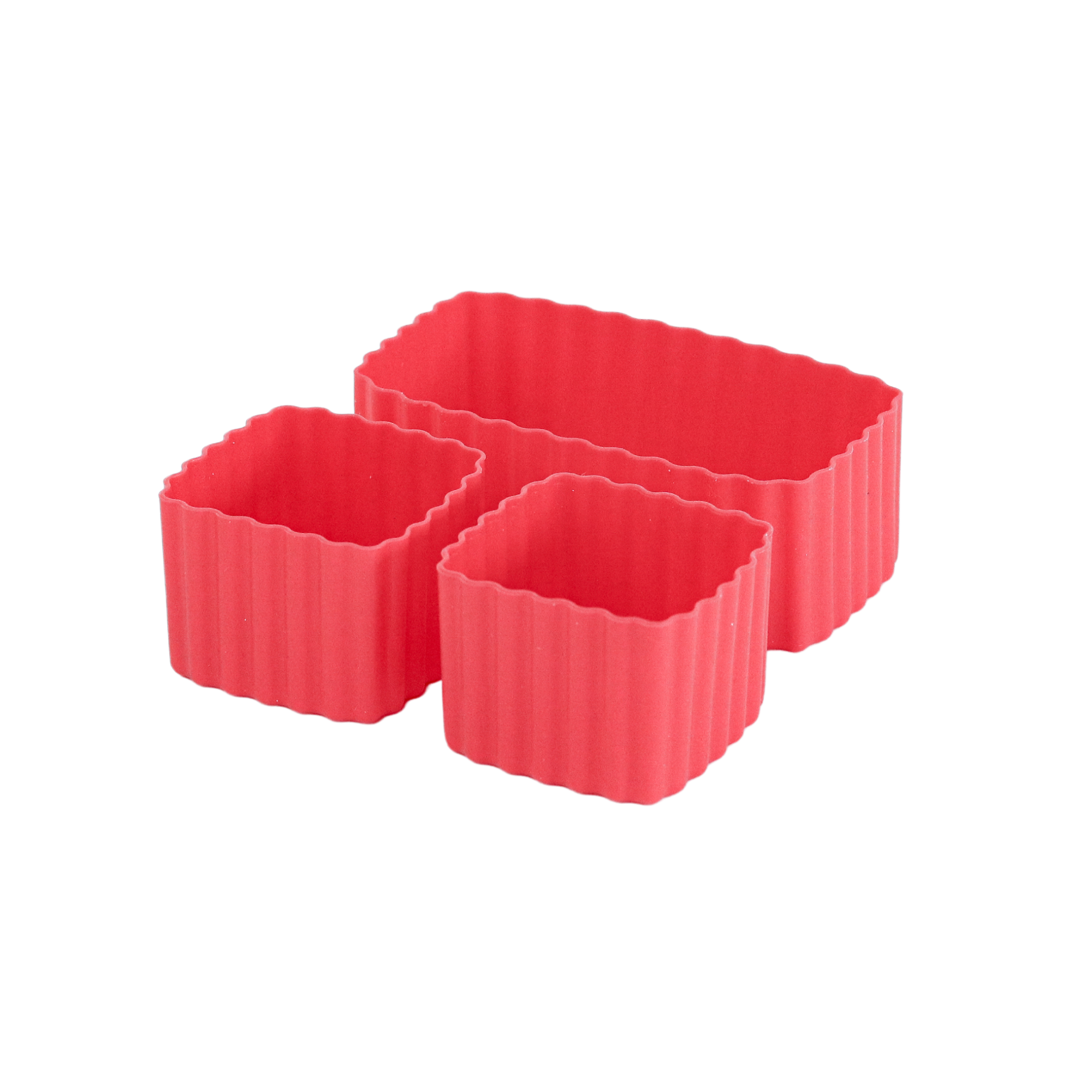 Three red silicone baking cups with textured sides on a white background